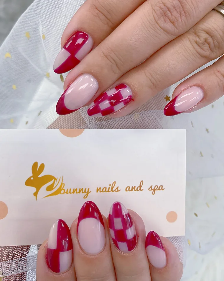 Almond nails with cranberry French tips and a checkerboard accent nail