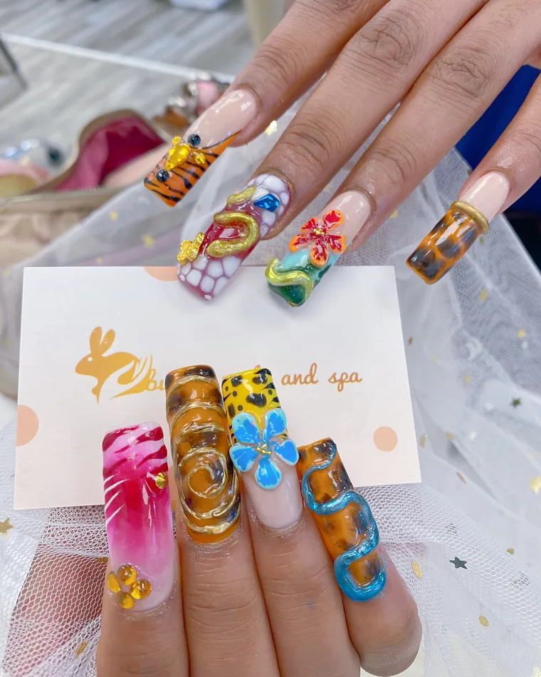 Long coffin nails in tortoiseshell and animal print with sculpted 3D flowers