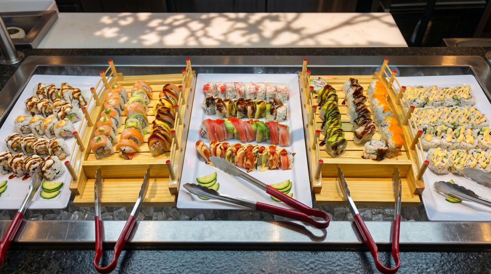 Trays of sushi rolls on the buffet line