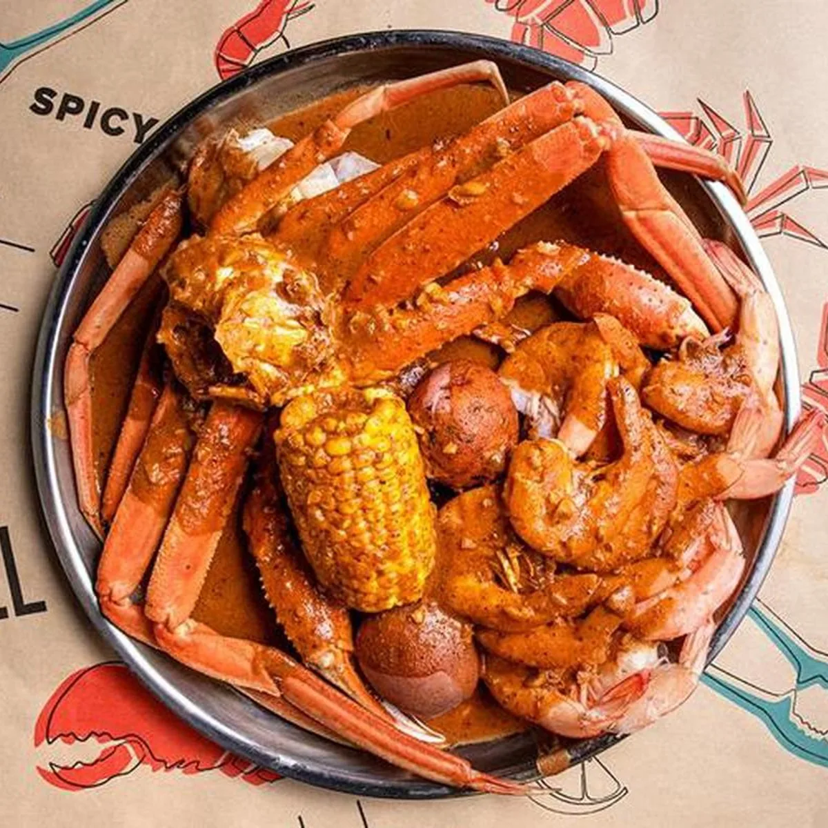 A Large Catch boil with snow crab legs, shrimp, corn and potatoes