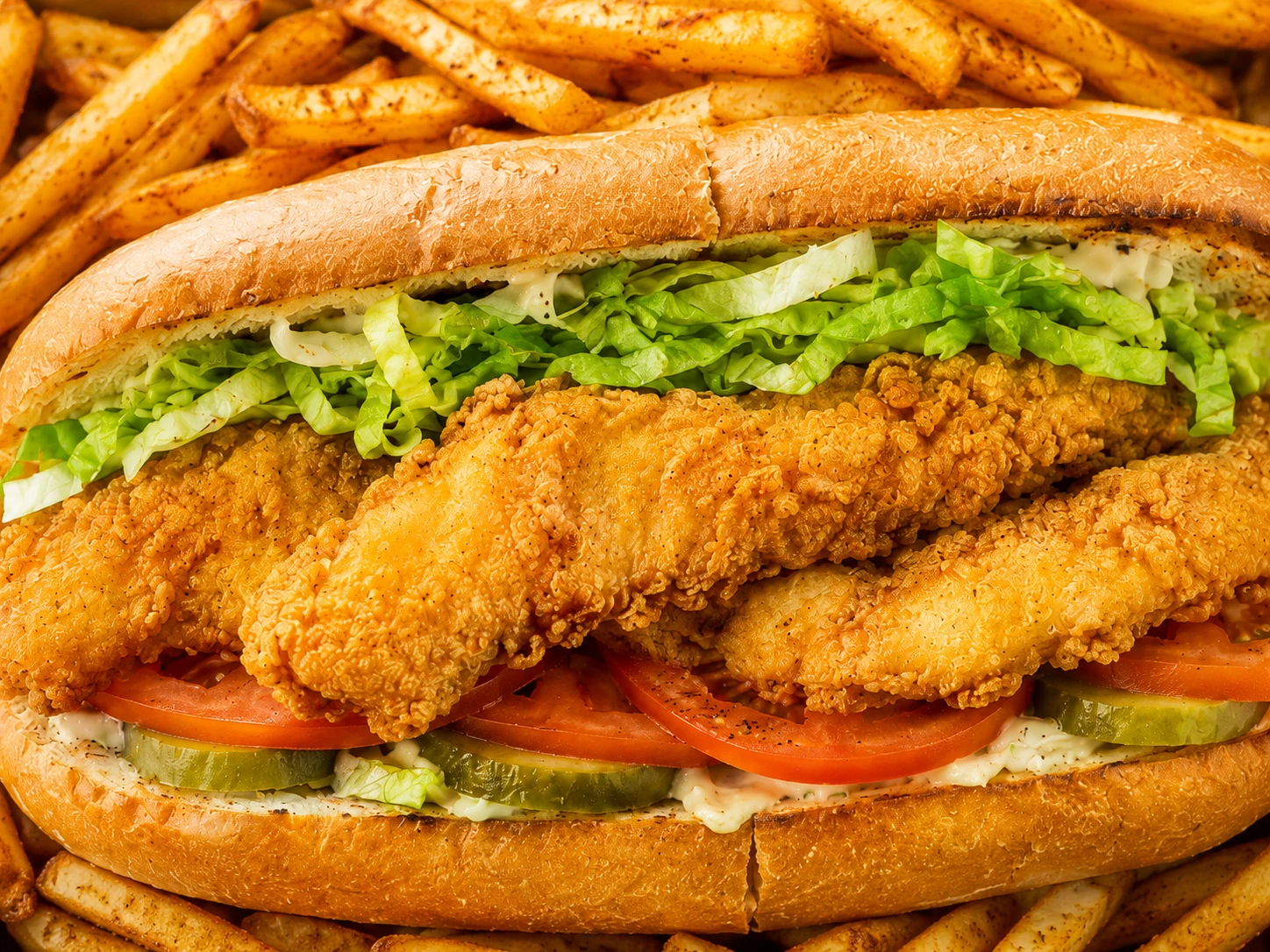 Golden fried catfish in a toasted po’boy with fresh lettuce, tomato, Cajun mayo and fries