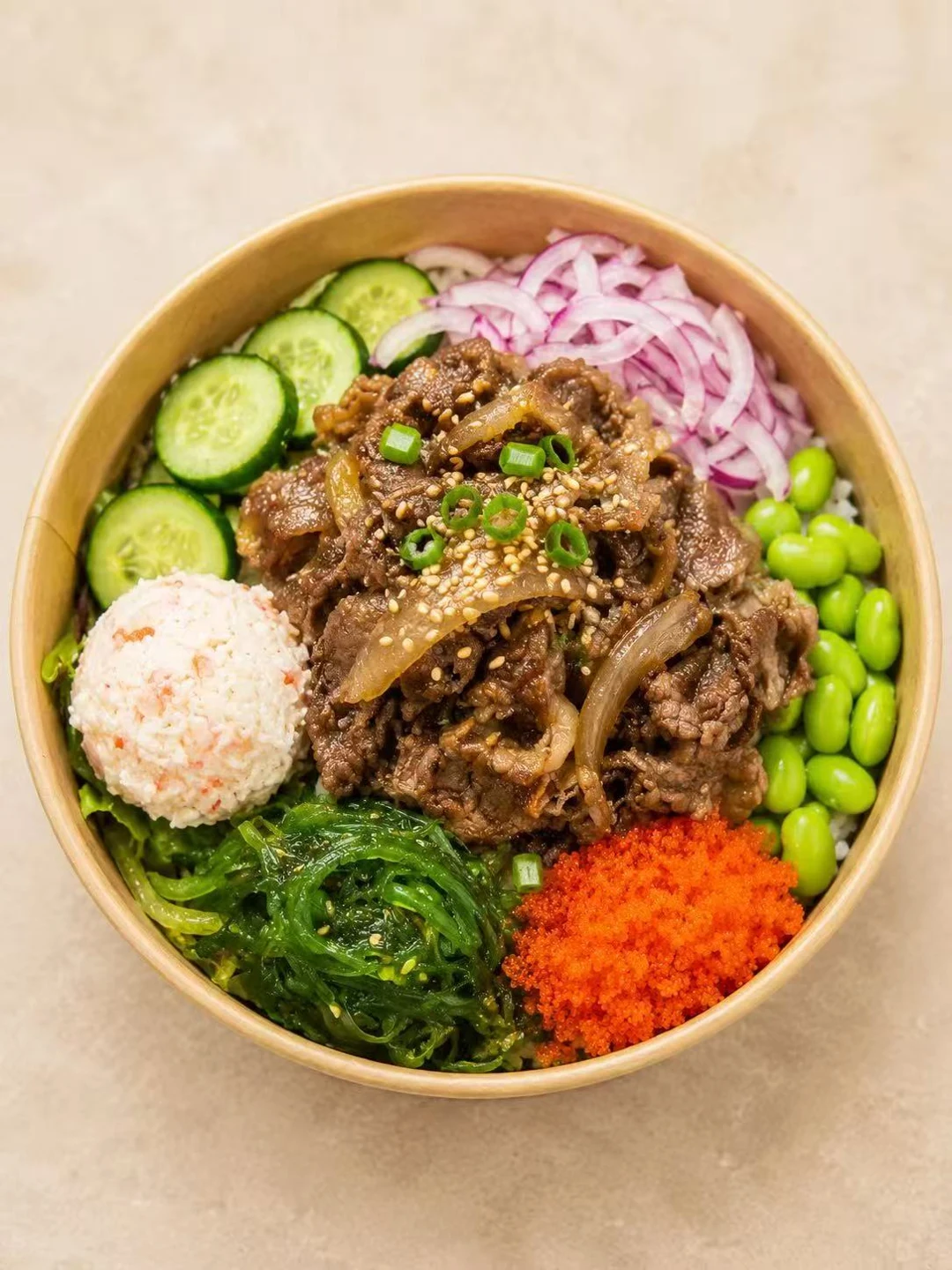Beef bowl with cucumber, edamame and seaweed salad
