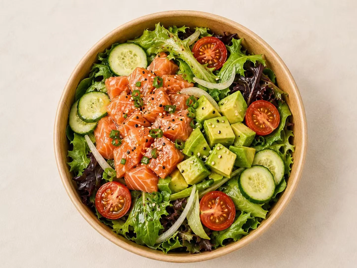 Salmon poki bowl with avocado, cucumber and greens
